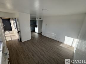 Fort Stockton apartment for rent - A spacious room with wooden flooring and white walls.