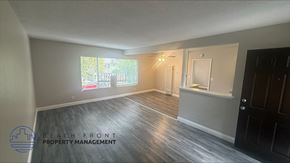 Garden Grove apartment for rent - A room with wooden flooring and a window showing a view of a beach.