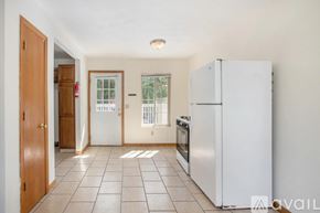 Kalamazoo house for rent - A kitchen with a refrigerator, oven, and a window.