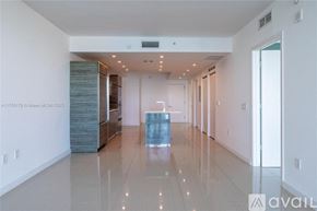 Miami apartment for rent - A spacious, well-lit room with a long hallway and a glass table in the middle.