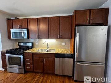 Chicago apartment for rent - A kitchen with wooden cabinets and stainless steel appliances.