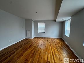Chicago apartment for rent - A room with wooden flooring and a window with blinds.
