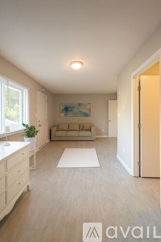 Franklin apartment for rent - A living room with a couch, a plant, and a painting on the wall.