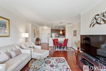 Westborough apartment for rent - A living room with a white couch, a red chair set, and a television.