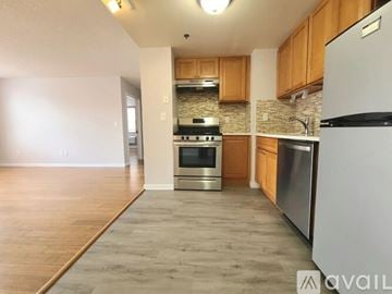 Bayonne apartment for rent - A kitchen with wooden cabinets and stainless steel appliances.