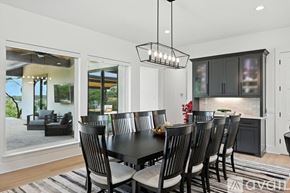 Gainesville house for rent - A black and white dining room with a large table and chairs.