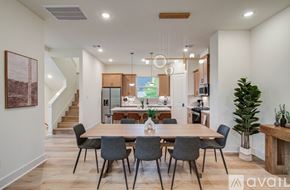 Houston townhouse for rent - A dining room with a wooden table and chairs.