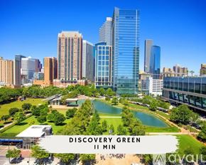 Houston townhouse for rent - A cityscape with a large green space in the foreground and a sign that reads "Discovery Green II Min.".