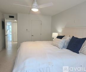 Longboat Key condo for rent - A bedroom with a large bed and a ceiling fan.