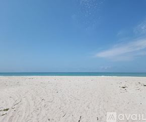 Longboat Key condo for rent - A beach with white sand and a clear blue sky.