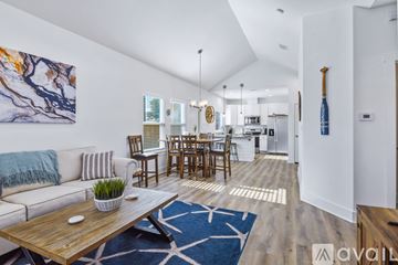 Rockport house for rent - A living room with a white couch and a wooden coffee table.