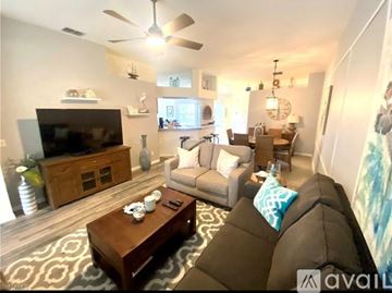 Naples apartment for rent - A living room with a brown couch and a wooden coffee table.