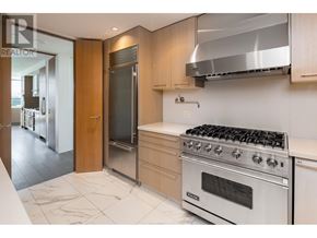 Vancouver apartment for rent - A modern kitchen with a stainless steel oven and a marble floor.