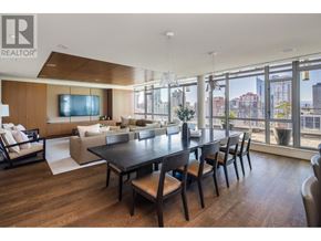 Vancouver apartment for rent - A modern living room with a large table and chairs.