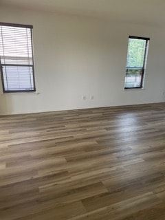 Cedar Park house for rent - A room with wooden flooring and two windows.