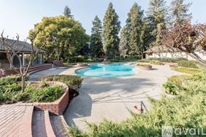 Fresno apartment for rent - A backyard with a pool and a tree.