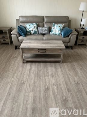 Oceanside house for rent - A grey couch with a wooden coffee table in front of it.