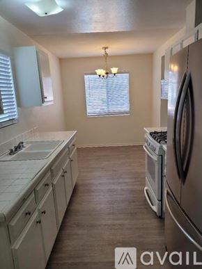Oceanside house for rent - A kitchen with a washer and dryer built in.