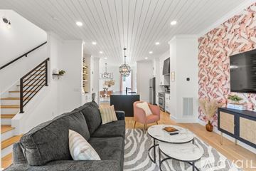 Nashville house for rent - A living room with a grey couch and a zebra print rug.