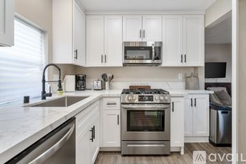 San Diego apartment for rent - A kitchen with white cabinets and stainless steel appliances.