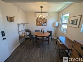 San Diego apartment for rent - A dining room with a round wooden table surrounded by chairs.