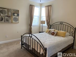 Nipomo house for rent - A bedroom with a large bed and a painting on the wall.