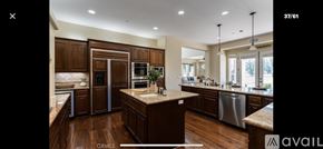 Nipomo house for rent - A kitchen with wooden cabinets and a central island.