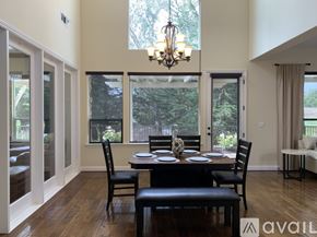 Nipomo house for rent - A dining room with a table set for four and a chandelier.