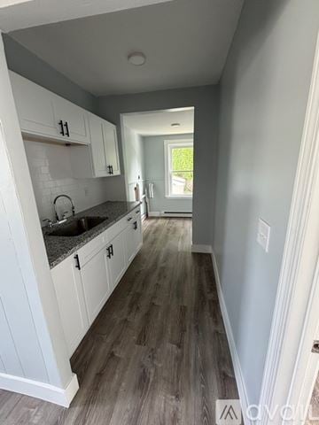 Providence apartment for rent - A kitchen with white cabinets and a grey floor.