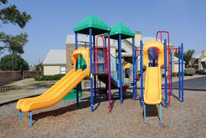 Midland apartment for rent - A playground with a yellow slide and a green roof.