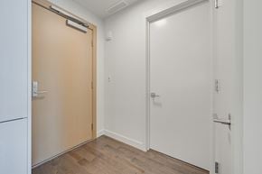 Edmonton apartment for rent - A white door with a silver handle is on the right side of the image.