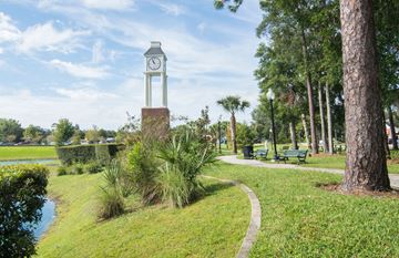Raleigh apartment for rent - A park with a clock tower and a pond.