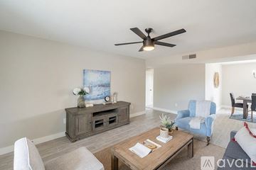Tempe house for rent - A living room with a ceiling fan and a painting on the wall.
