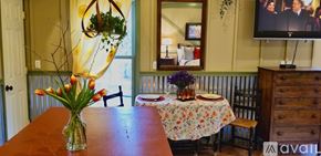 Lake Lure house for rent - A dining room with a table set for two and a vase of flowers on the table.