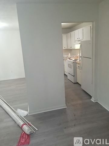 Athens house for rent - A kitchen with white cabinets and appliances is shown.