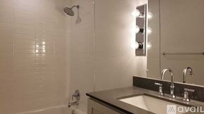 Dallas apartment for rent - A bathroom with a sink, mirror, and shower.