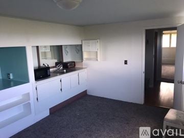 Kailua-Kona apartment for rent - A kitchen with white cabinets and a microwave on the counter.