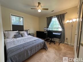 Riverdale house for rent - A bedroom with a bed, desk, and chair.