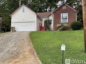 Riverdale house for rent - A house with a garage and a driveway in front of it.