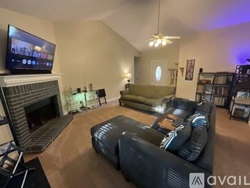 Riverdale house for rent - A living room with a fireplace and a television on the wall.