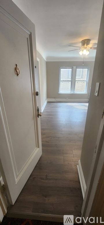 Oak Park apartment for rent - A kitchen with white cabinets and a tiled floor.