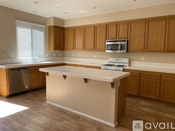 Temecula house for rent - A kitchen with wooden cabinets and a white island.