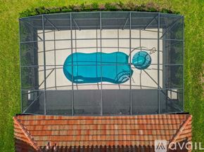 Davenport house for rent - A blue hot tub is surrounded by a metal cage.