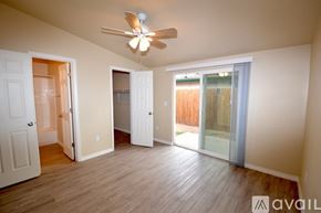 Albuquerque apartment for rent - A spacious apartment living room with a ceiling fan and built-in shelves.