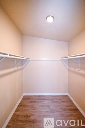 Albuquerque apartment for rent - A well-lit, empty apartment with a ceiling fan and a refrigerator.