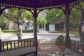 Clinton apartment for rent - a gazebo with a bench in front of a building