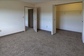 Clinton apartment for rent - a room with carpet and white walls and doors