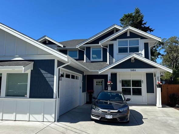 Victoria apartment for rent - A two-story house with a garage and a car parked in front.