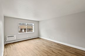 Denver apartment for rent - Empty room with wooden floor and a window.