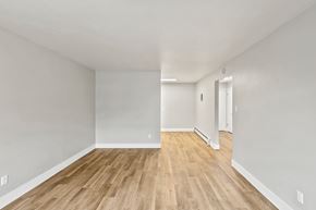 Denver apartment for rent - A room with wooden flooring and white walls.